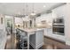 Bright, spacious kitchen with a large island, stainless appliances, and white cabinets at 175 Lockamy Ln, Youngsville, NC 27596