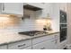 Modern kitchen featuring granite countertops, stainless steel appliances, and sleek white cabinetry at 175 Lockamy Ln, Youngsville, NC 27596