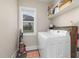 Bright laundry room with a modern washer and dryer, a window, and open shelving at 175 Lockamy Ln, Youngsville, NC 27596