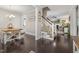 Open concept living room and dining room featuring hardwood floors and a staircase to the second floor at 175 Lockamy Ln, Youngsville, NC 27596