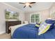 Comfortable main bedroom showcasing a TV over a wooden dresser and a large window at 175 Lockamy Ln, Youngsville, NC 27596