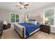 Serene main bedroom featuring a plush bed, natural light, and stylish decor at 175 Lockamy Ln, Youngsville, NC 27596