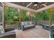 Cozy screened porch with stylish seating and views of the surrounding greenery at 175 Lockamy Ln, Youngsville, NC 27596