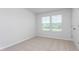 A carpeted bedroom features a window with natural light at 1907 Hinesley Dr, Durham, NC 27703