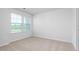 Light filled bedroom with neutral carpet and a view of the outdoors at 1913 Hinesley Dr, Durham, NC 27703