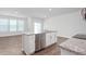 Open-concept kitchen with island, stainless steel appliances, granite countertops, hardwood floors, and natural light at 1913 Hinesley Dr, Durham, NC 27703