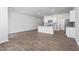 Open-concept living area featuring a kitchen with an island, stainless steel appliances, and hardwood floors at 1913 Hinesley Dr, Durham, NC 27703