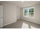 Bright, carpeted bedroom with a ceiling light and double windows at 1915 Hinesley Dr, Durham, NC 27703