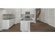 Bright kitchen features white cabinetry, stainless steel appliances, an island with sink, and a modern aesthetic at 1915 Hinesley Dr, Durham, NC 27703