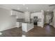Spacious kitchen with white cabinets, modern appliances, an island with a sink, and dark wood flooring at 1915 Hinesley Dr, Durham, NC 27703