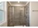 Modern bathroom featuring a glass shower with tiled walls and a built-in niche at 1915 Hinesley Dr, Durham, NC 27703