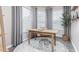 Bright office space has three windows, neutral walls, gray curtains, and a modern wooden desk with chair at 1917 Hinesley Dr, Durham, NC 27703