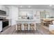 Modern kitchen features gray cabinets, stainless appliances, granite countertops, island with stools and tile backsplash at 1917 Hinesley Dr, Durham, NC 27703