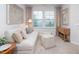 Cozy living room with a comfortable sofa, striped ottomans, natural light, and neutral decor at 1917 Hinesley Dr, Durham, NC 27703