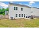 Fenced backyard offering ample lawn space, an outdoor seating area, and mature trees for a private, relaxing oasis at 200 Chateau Way, Angier, NC 27501