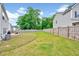 Lush backyard featuring a spacious lawn and a fenced perimeter, offering privacy and space for outdoor activities and relaxation at 200 Chateau Way, Angier, NC 27501
