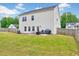 Spacious backyard with a well-maintained lawn, patio with furniture, and fenced perimeter for private outdoor enjoyment at 200 Chateau Way, Angier, NC 27501