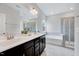 Bright bathroom featuring a double vanity, separate shower, and soaking tub at 200 Chateau Way, Angier, NC 27501