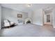 Neutral bedroom with gray walls and carpet featuring a white rocking chair and tent at 200 Chateau Way, Angier, NC 27501
