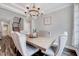 Elegant dining room with a rustic chandelier, crown molding, and seating for six at 200 Chateau Way, Angier, NC 27501