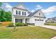 Attractive two-story house with a green lawn, a porch with columns, and a two-car garage at 200 Chateau Way, Angier, NC 27501