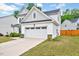 View of the two-car garage with a concrete driveway, showcasing the home's ample parking at 200 Chateau Way, Angier, NC 27501