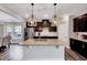 Modern kitchen featuring a large island with granite countertops and dark cabinets at 200 Chateau Way, Angier, NC 27501