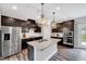 Modern kitchen with stainless steel appliances, dark cabinetry, and a large center island at 200 Chateau Way, Angier, NC 27501