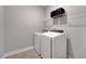 Laundry room featuring modern washer and dryer appliances, with a storage shelf above at 200 Chateau Way, Angier, NC 27501