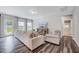 Bright living room with wood flooring and a view of the outdoor space through glass doors at 200 Chateau Way, Angier, NC 27501