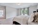 Neutral main bedroom featuring a large window, tray ceiling, and dark wood furniture at 200 Chateau Way, Angier, NC 27501
