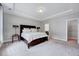 Spacious main bedroom with tray ceiling featuring a large bed and ensuite bathroom and walk-in closet at 200 Chateau Way, Angier, NC 27501