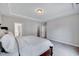 Neutral main bedroom featuring a tray ceiling, ensuite bathroom, and walk-in closet at 200 Chateau Way, Angier, NC 27501