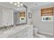 Elegant bathroom features a double vanity with marble countertop, large mirror and natural light at 2006 Keokuk Ct, Apex, NC 27523