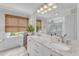 Elegant bathroom featuring a double vanity with marble countertops and framed mirror at 2006 Keokuk Ct, Apex, NC 27523