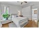 Bright bedroom with hardwood floors, a metal frame bed, and a neutral color scheme at 2006 Keokuk Ct, Apex, NC 27523