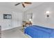 Neutral bedroom features a desk, double closet, ceiling fan and a bed with blue comforter at 2006 Keokuk Ct, Apex, NC 27523
