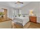 Cozy bedroom with a metal frame bed, natural light from windows, and an earthy aesthetic at 2006 Keokuk Ct, Apex, NC 27523