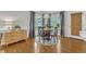 Charming dining area with large windows, hardwood floors, and a stylish light fixture at 2006 Keokuk Ct, Apex, NC 27523