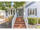 Inviting front porch with brick steps, white railings, and a stylish front door at 2006 Keokuk Ct, Apex, NC 27523