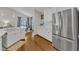 Kitchen with stainless refrigerator, and views to the eat in kitchen area and living room at 2006 Keokuk Ct, Apex, NC 27523