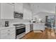 Kitchen features stainless appliances, white subway tile, and views to the breakfast nook at 2006 Keokuk Ct, Apex, NC 27523