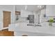 Spacious kitchen with quartz countertops, stainless steel appliances, and woven window shades at 2006 Keokuk Ct, Apex, NC 27523