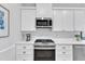 Clean kitchen with white cabinets, stainless steel appliances and gas range at 2006 Keokuk Ct, Apex, NC 27523
