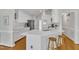Kitchen features white cabinets, quartz counters, stainless appliances, and pendant lights at 2006 Keokuk Ct, Apex, NC 27523