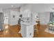 Bright open kitchen with white cabinets, stainless appliances, and hardwood floors at 2006 Keokuk Ct, Apex, NC 27523