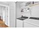 Practical laundry room with washer, dryer, shelving and plenty of storage space at 2006 Keokuk Ct, Apex, NC 27523
