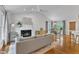Bright living room with vaulted ceilings, fireplace, and hardwood floors, flowing into dining area at 2006 Keokuk Ct, Apex, NC 27523