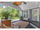 Relaxing screened-in porch with ceiling fan, wicker furniture and view of the backyard at 2006 Keokuk Ct, Apex, NC 27523