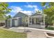 Charming home featuring a covered porch, fire pit, and manicured landscaping in the backyard at 2006 Keokuk Ct, Apex, NC 27523